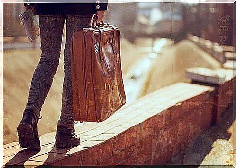 young man carrying a suitcase