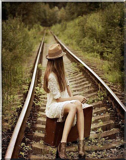 the girl sits on a deserted track